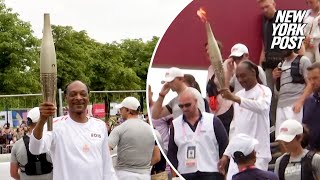 WATCH Snoop Dogg carries Olympic torch ahead of 2024 Opening Ceremony [upl. by Chickie676]