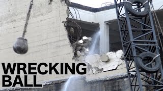 Wrecking ball in action demolishing a concrete building [upl. by Acenom]