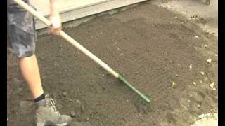 Smoothing the soil prior to laying turf by London Lawn Turf [upl. by Ravo]