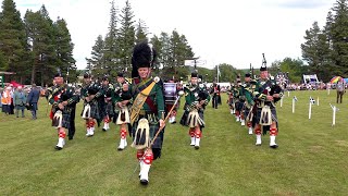 Drum Major leads Huntly Pipe Band playing on the march during Tomintoul Highland Games in Scotland [upl. by Asus]