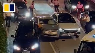 Driver tries to smash past Hong Kong roadblock in viral video [upl. by Ocicnarf]