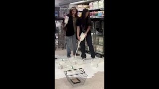 Climate activists pour milk over supermarket floor [upl. by Enelrats55]