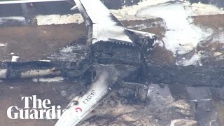 Aerials show plane wreckage after crash at Japans Haneda airport [upl. by Erhart]