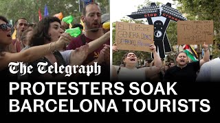 Antitourism protesters soak diners with water pistols in Barcelona [upl. by Eninaj76]