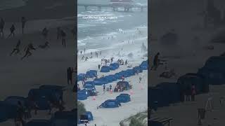 Footage captures waterspout ripping through crowded beach Shorts [upl. by Nylde]