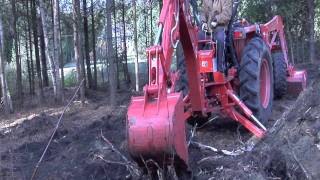 Kubota L4400 BH92 Backhoe Digging Large Tree Stumb Out [upl. by Leahkim56]