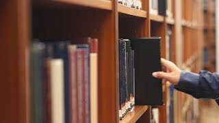 Man Picking Books in Library 01  Free Stock Footage 4K [upl. by Otit]