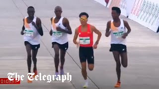 Runners appear to let Chinese contestant win Beijing halfmarathon [upl. by Edobalo]