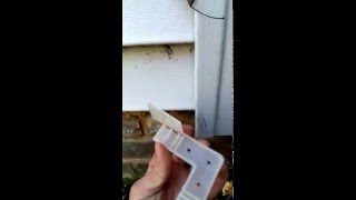 Mouse proofing a home in Cleveland OH by installing a critter cap on the corner of vinyl siding [upl. by Bullard]