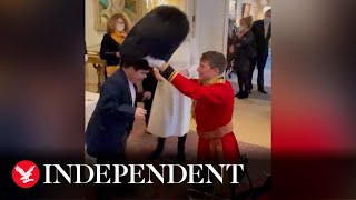 Adorable moment boy tries on Clarence House beefeater’s bearskin hat [upl. by Keane]