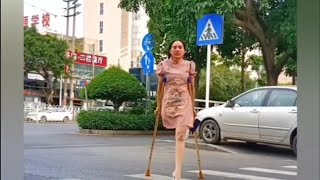 The beautiful woman with an amputated leg walking on crutches in the middle of the city [upl. by Charis]