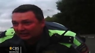 Watch Russian police officer clings to hood of car [upl. by Aihsenal]